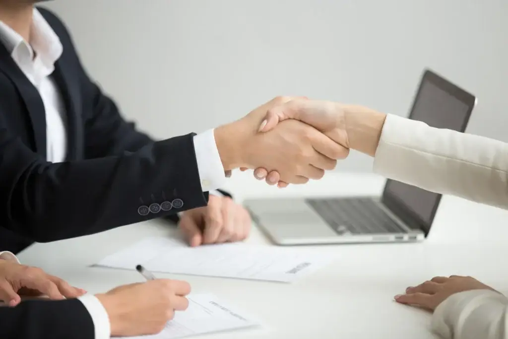 Employer and candidate shaking hands after a meeting