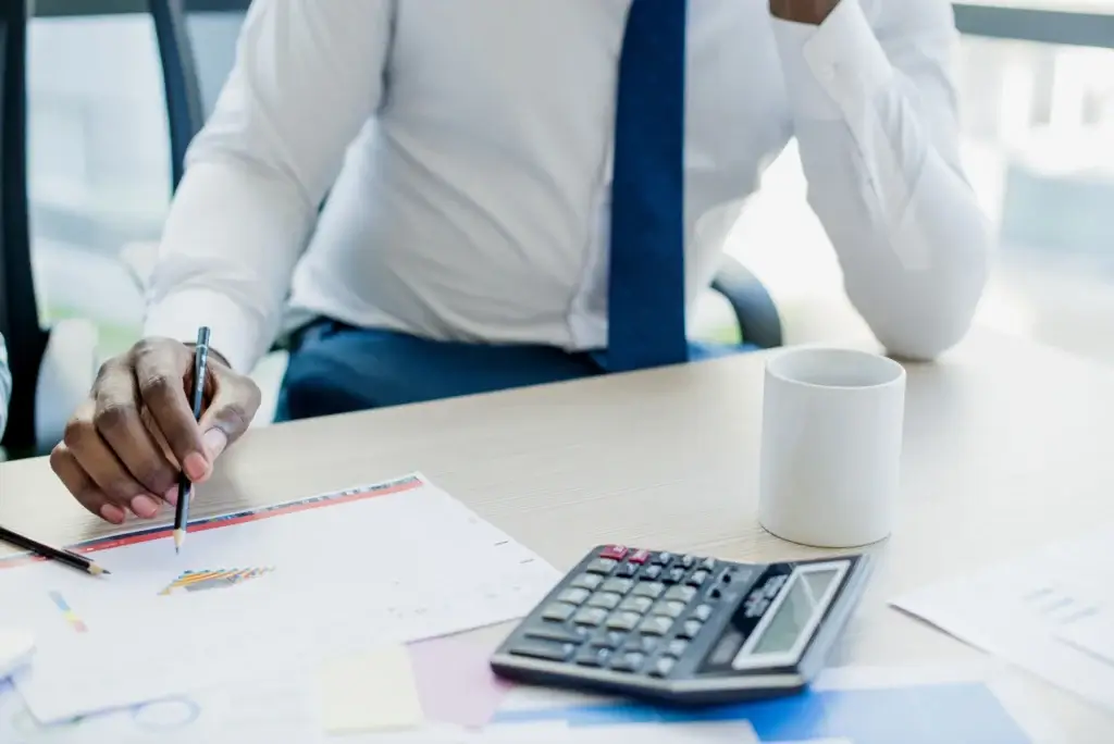 Office worker reviewing payroll calculations